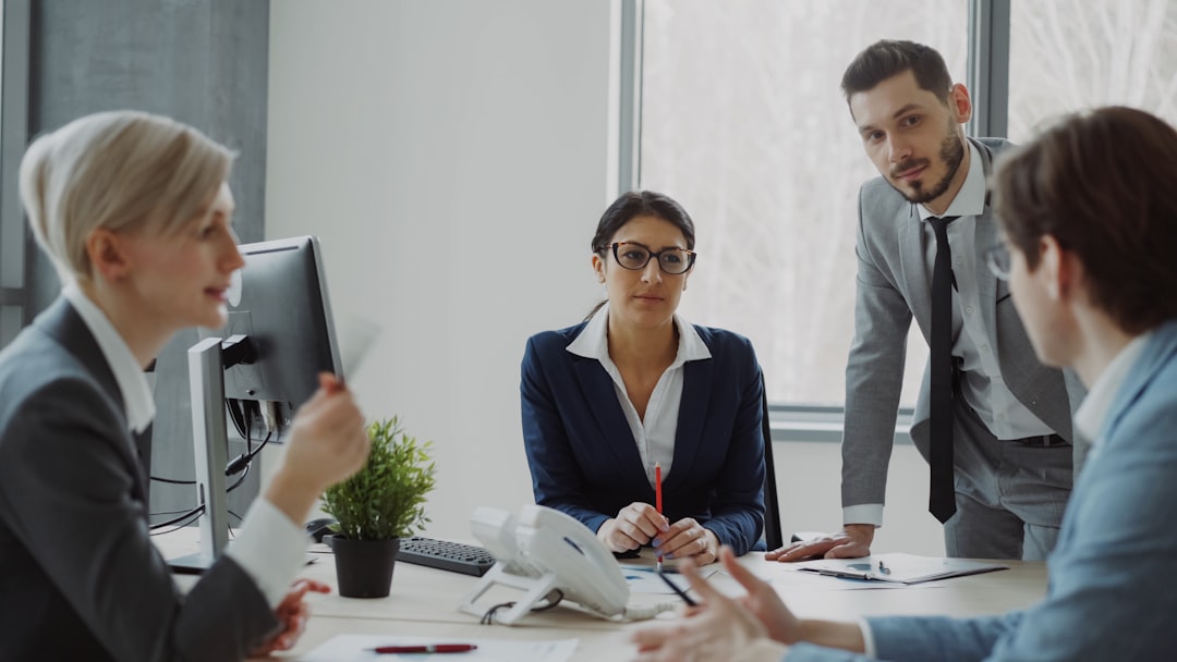 Business team collaborating and discussing strategy around a conference table in an office