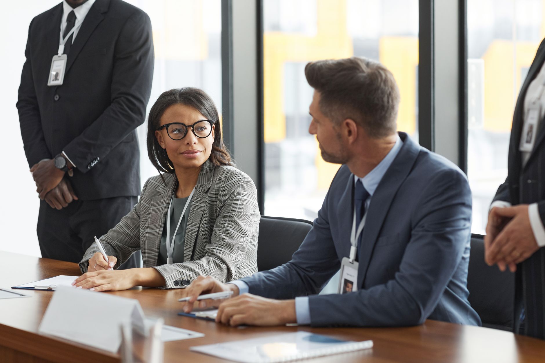 Business professionals discuss brand strategy around a conference table in an office setting