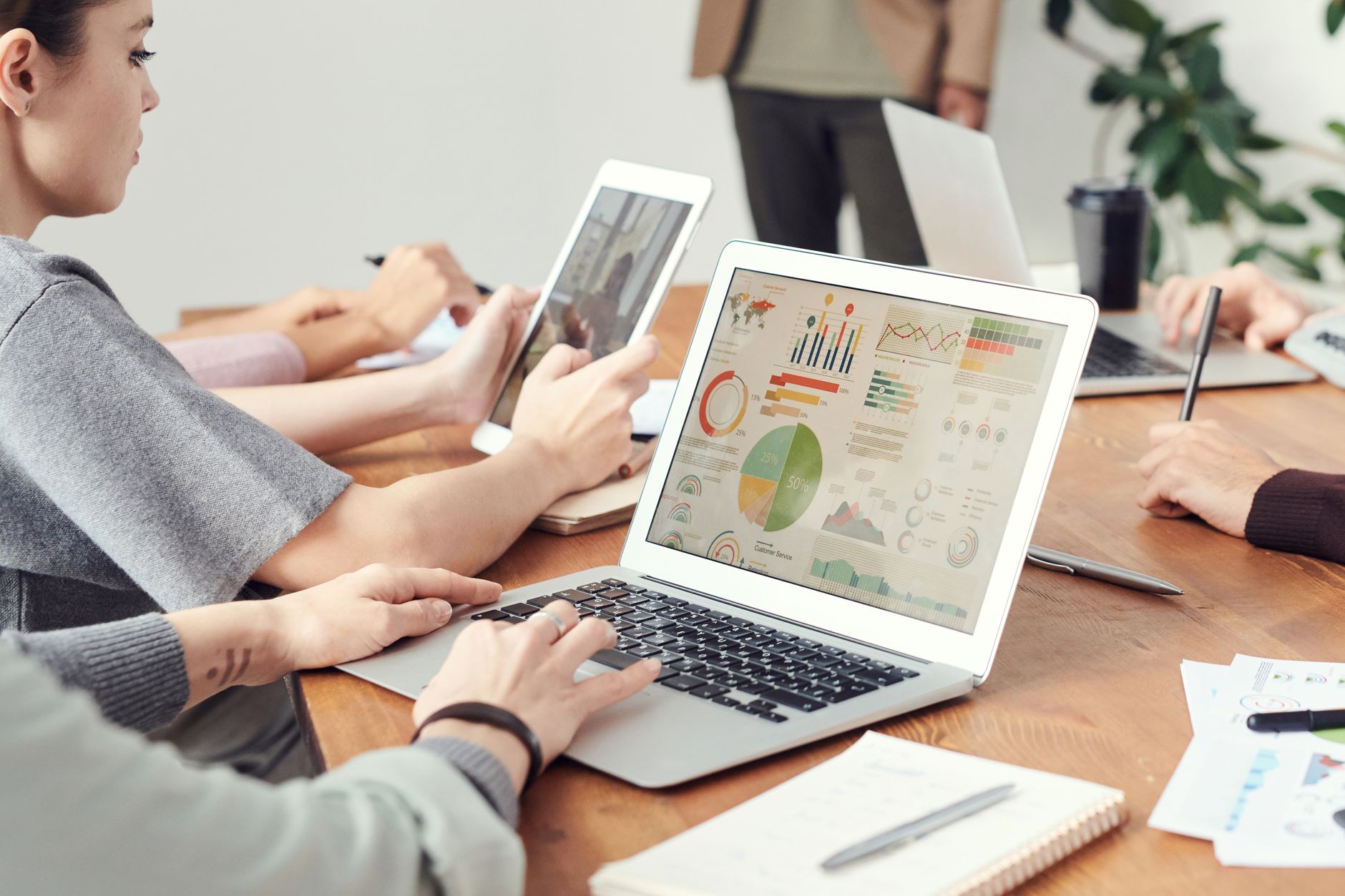 Team members analyze search performance charts on a laptop during a strategy meeting