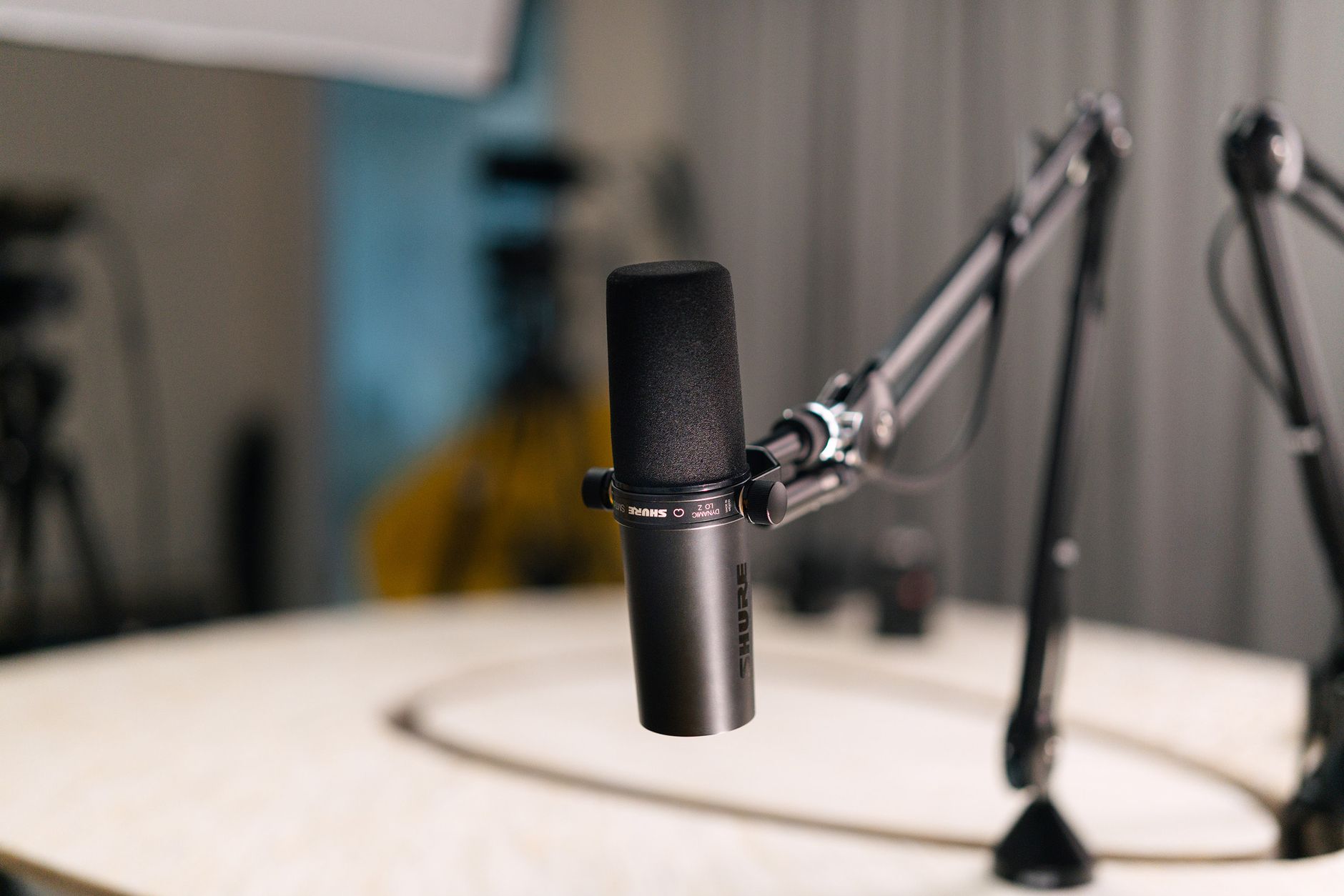 A Shure podcast microphone on an arm, ready for recording authentic conversations