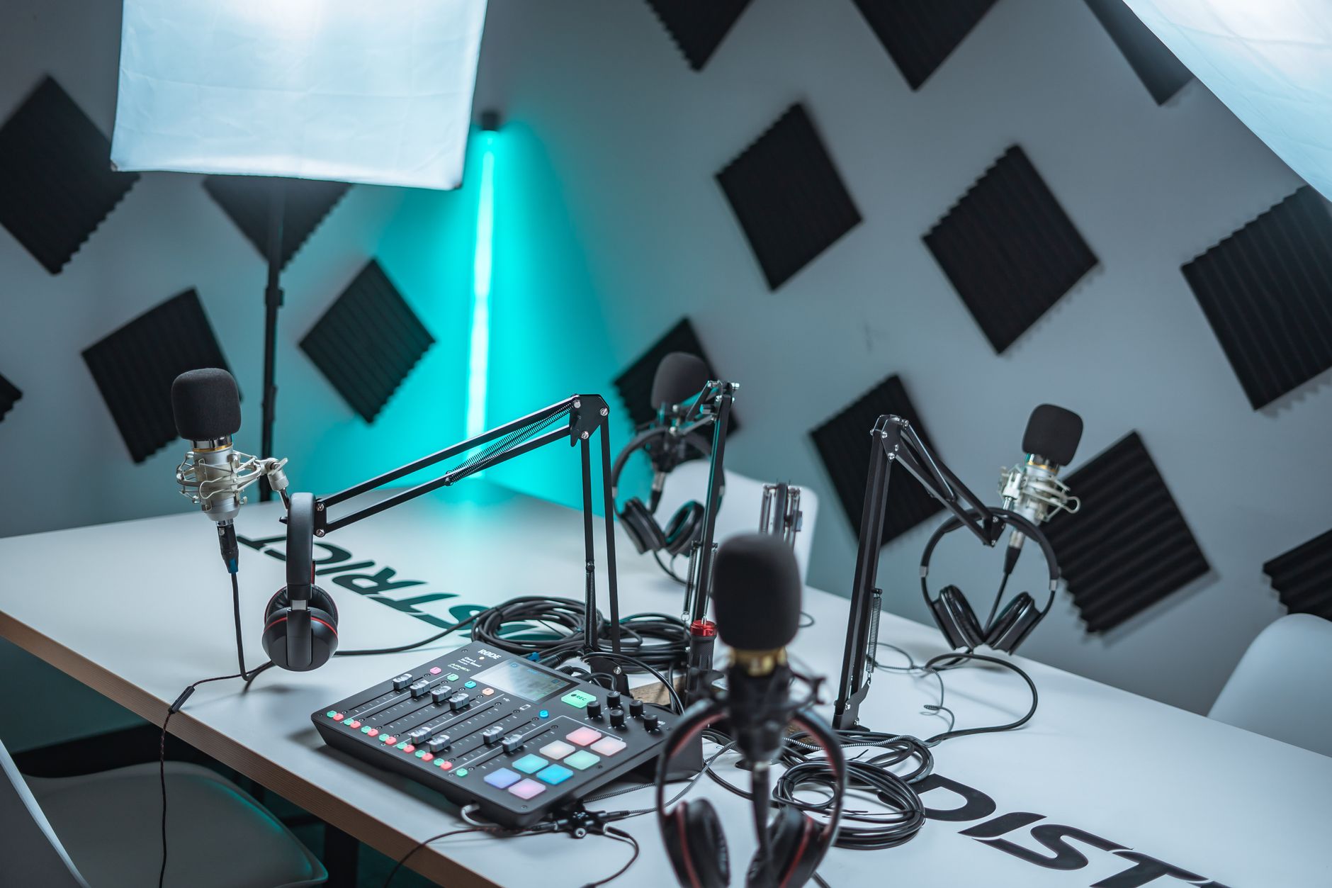 A podcast studio with multiple microphones, headphones, and a sound mixer