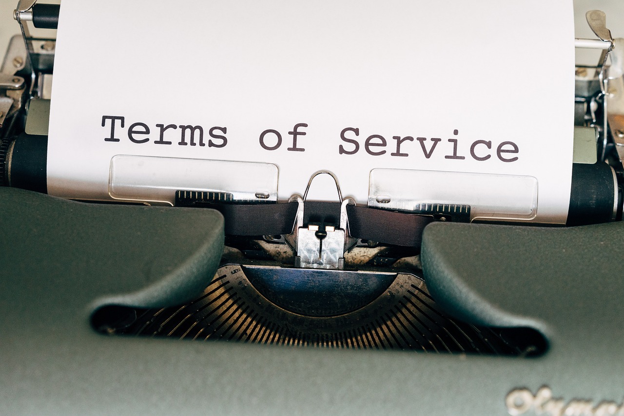 Typewritten "Terms of Service" on paper within an old manual typewriter