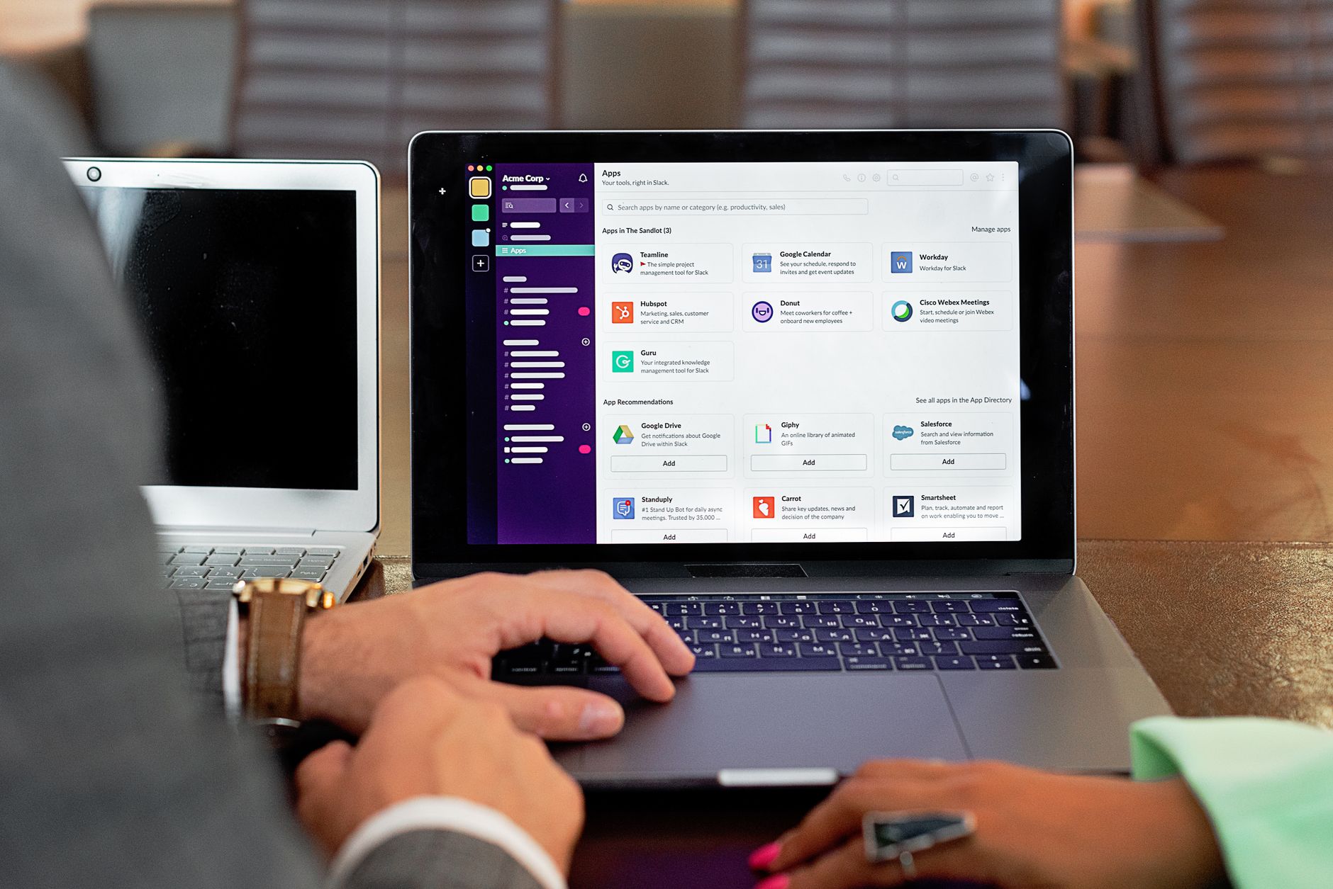 Person typing on a laptop screen displaying a business software apps directory