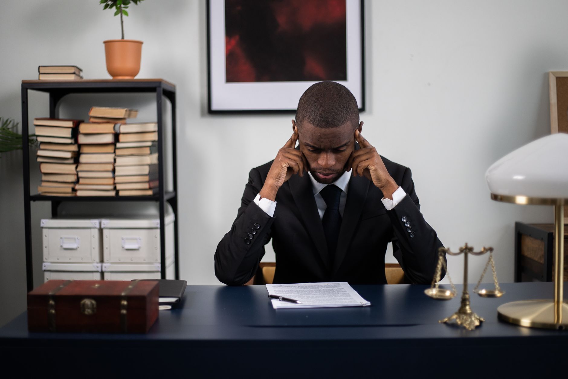 A thoughtful lawyer in his office considering complex trademark registration costs