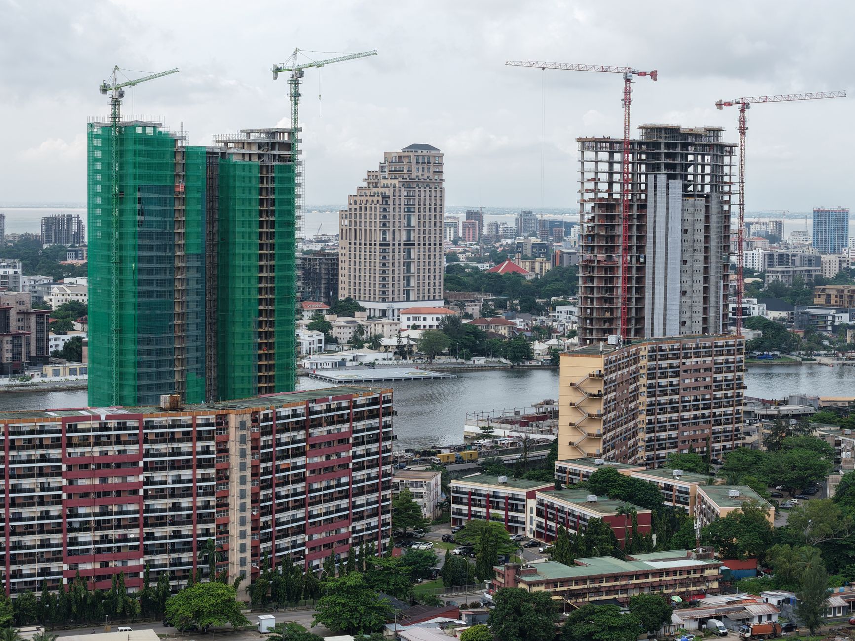 Lagos cityscape showing tall buildings, new construction with cranes, and waterways