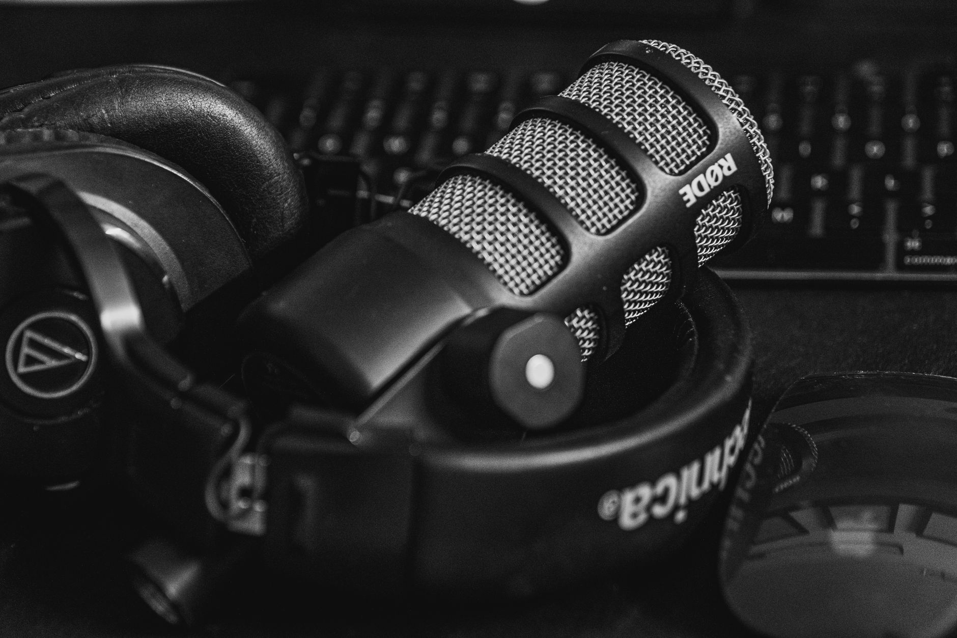 Black and white RODE microphone on Audio-Technica headphones for podcast recording