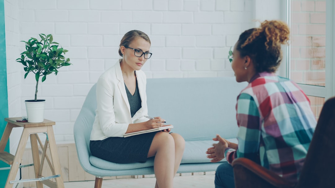 A female therapist consults with a client in a bright, modern office