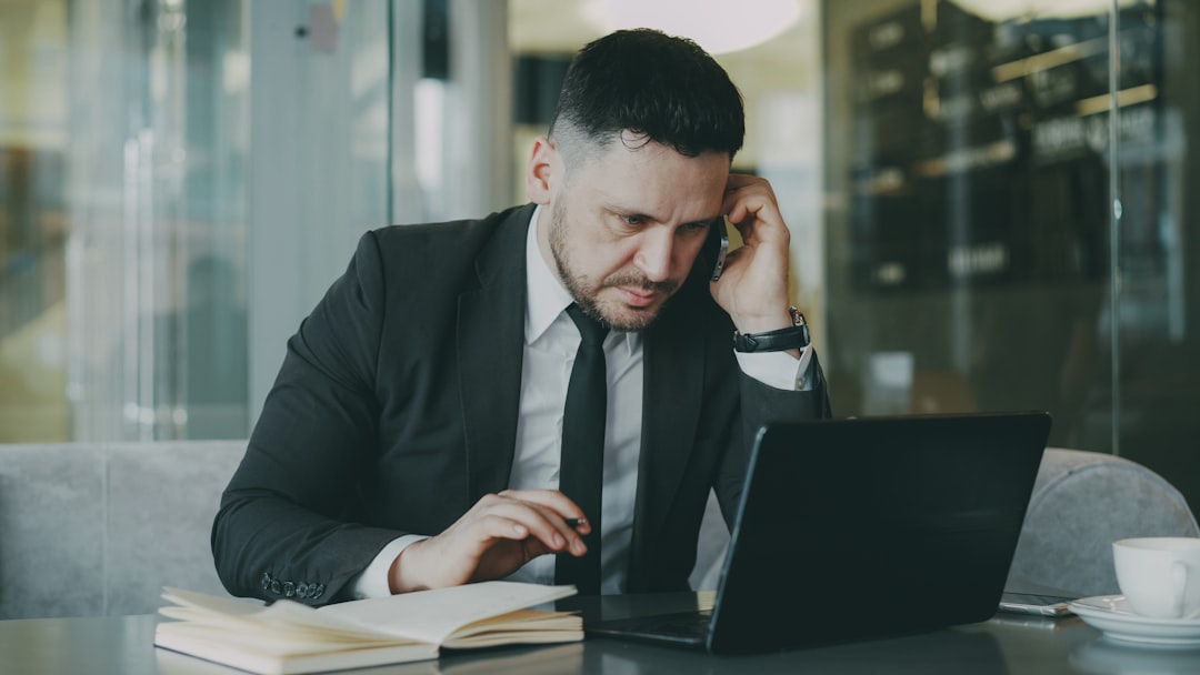 A focused businessman on a call, working on his laptop for ecommerce development