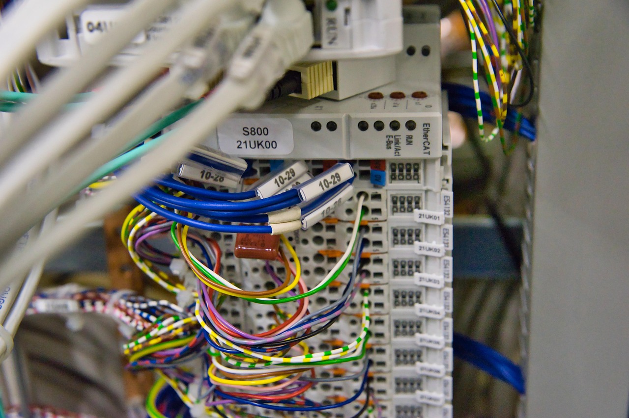 Colorful wires connect to automation hardware with labeled modules and ports