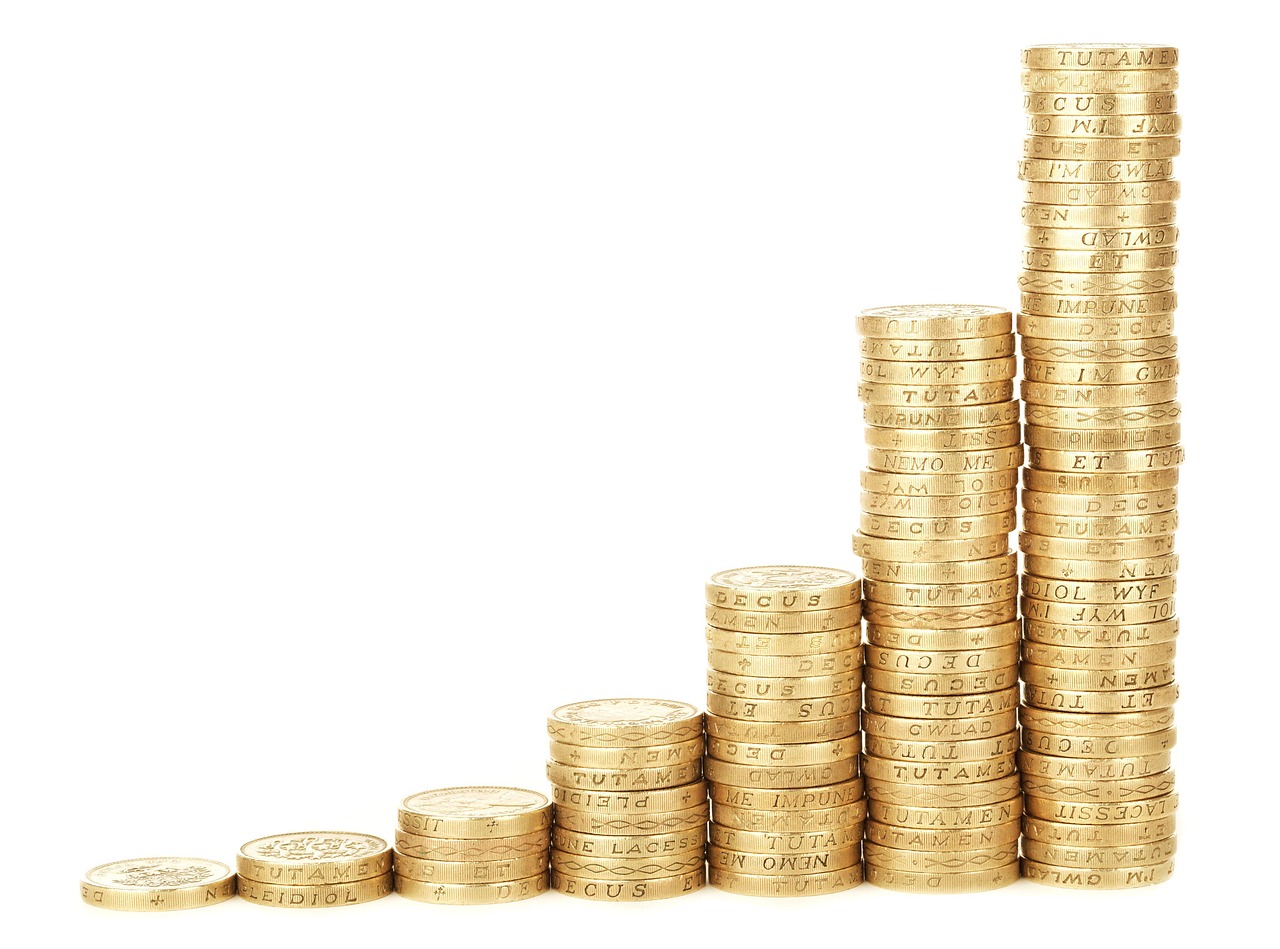 Stacks of golden coins increase in height against a white background, representing business growth