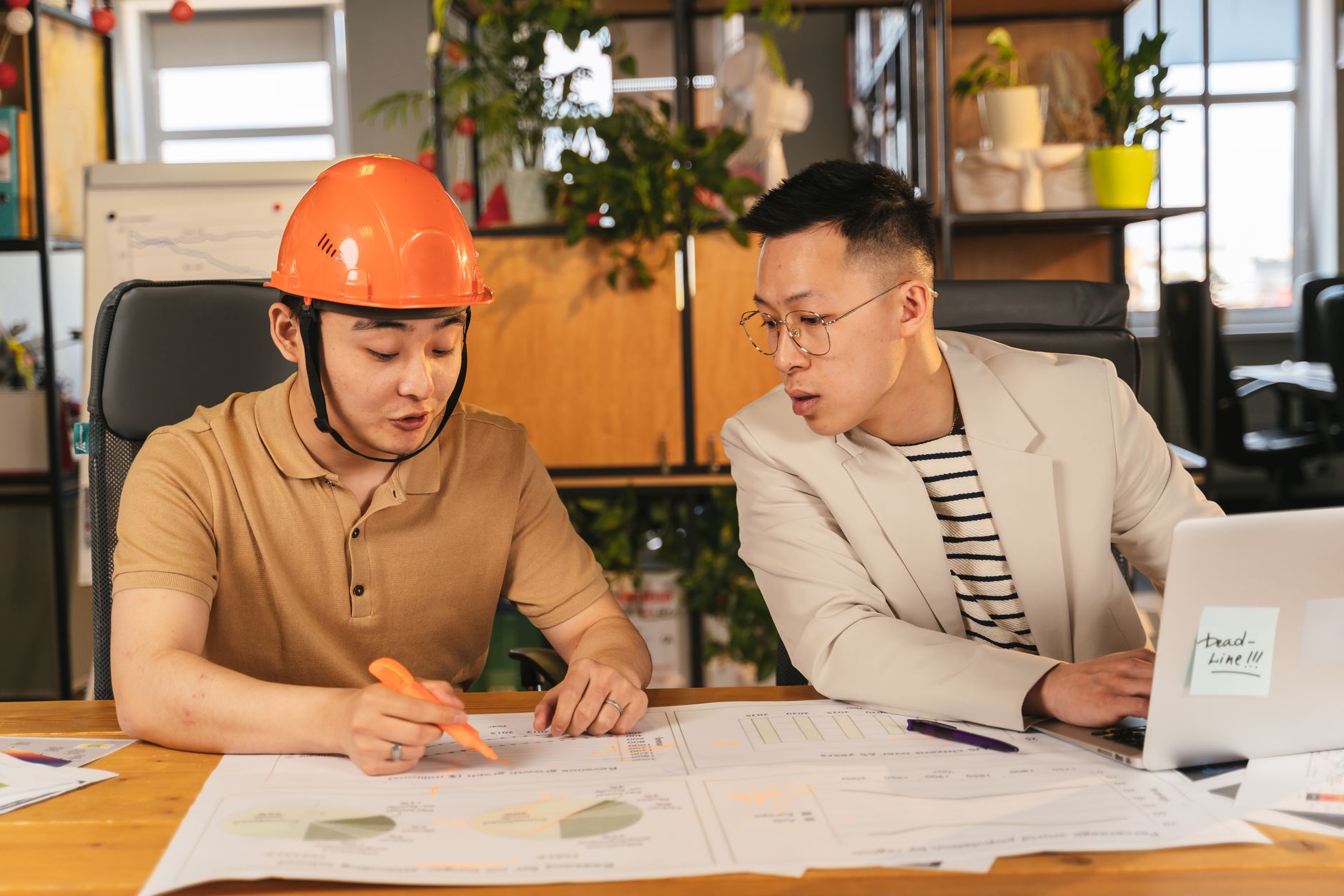 Two men review data and charts, demonstrating a verifiable portfolio project