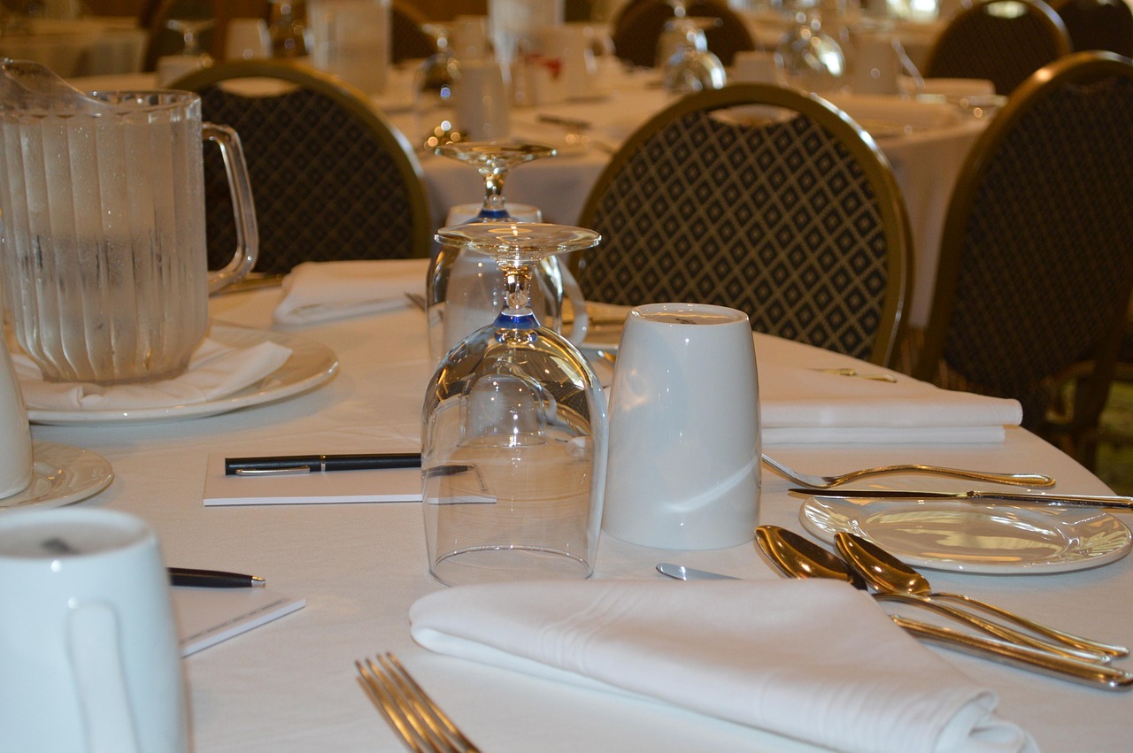 Table set for a meeting or negotiation with notepad, pen, and water pitcher