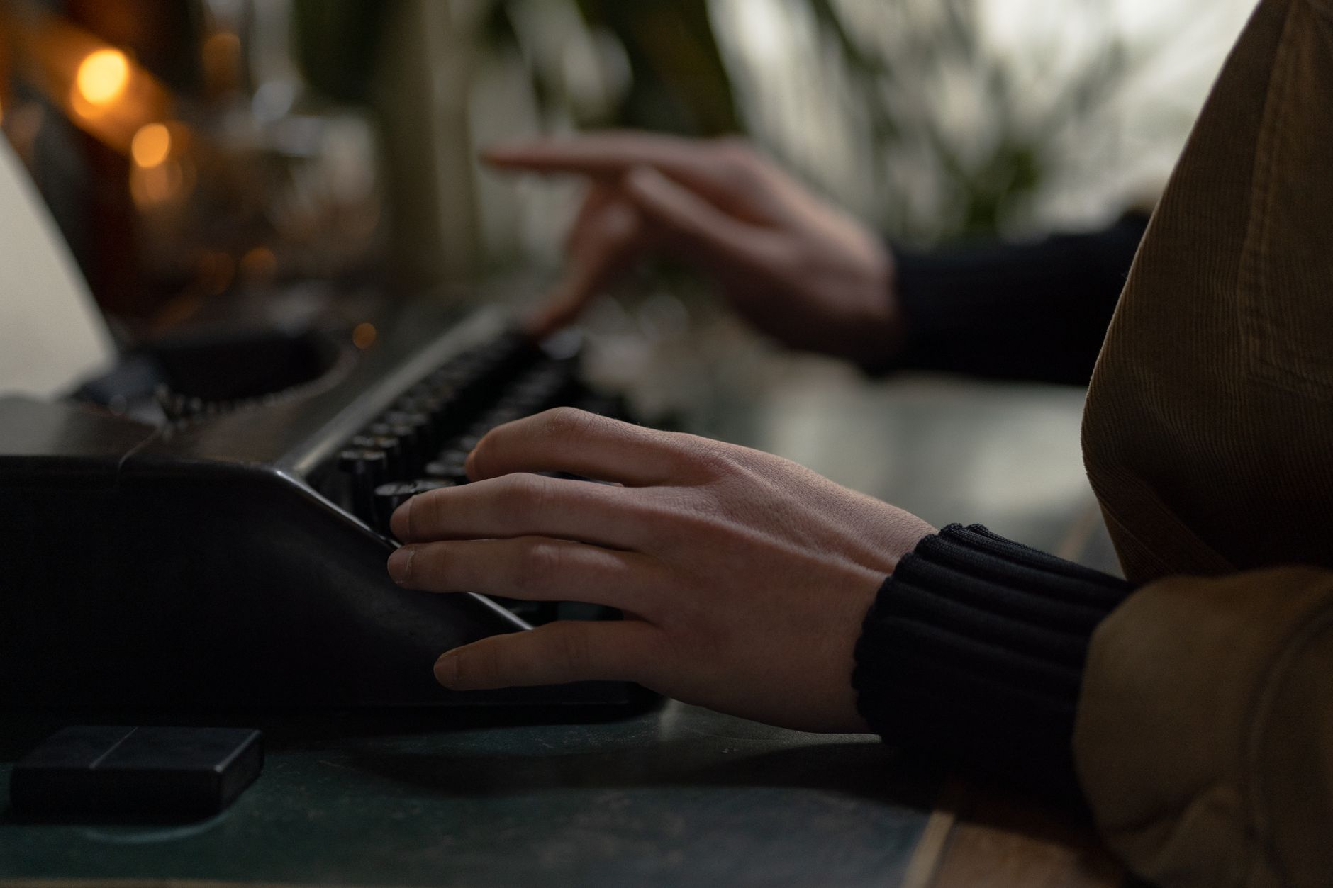 Hands typing on a classic typewriter, symbolizing content creation