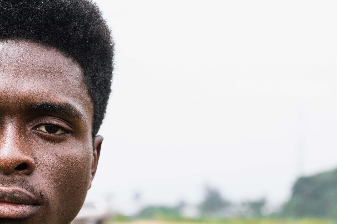Close-up of a young Nigerian man's face, illustrating human data subject impact