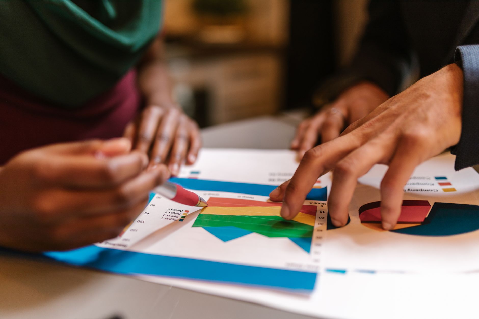 Hands analyzing data charts and graphs, likely for SEO strategy