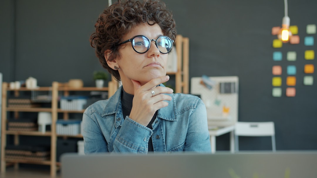 Woman in glasses looks thoughtful, contemplating what service branding is not