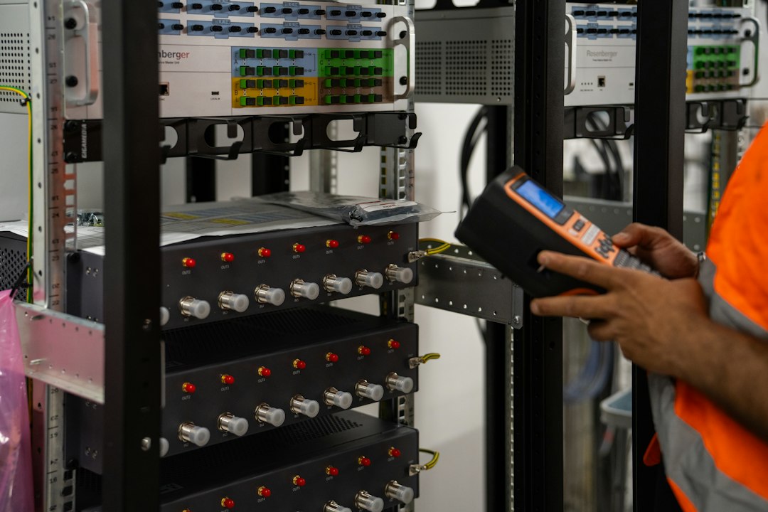 Technician testing network equipment and servers in a rack for scalable infrastructure