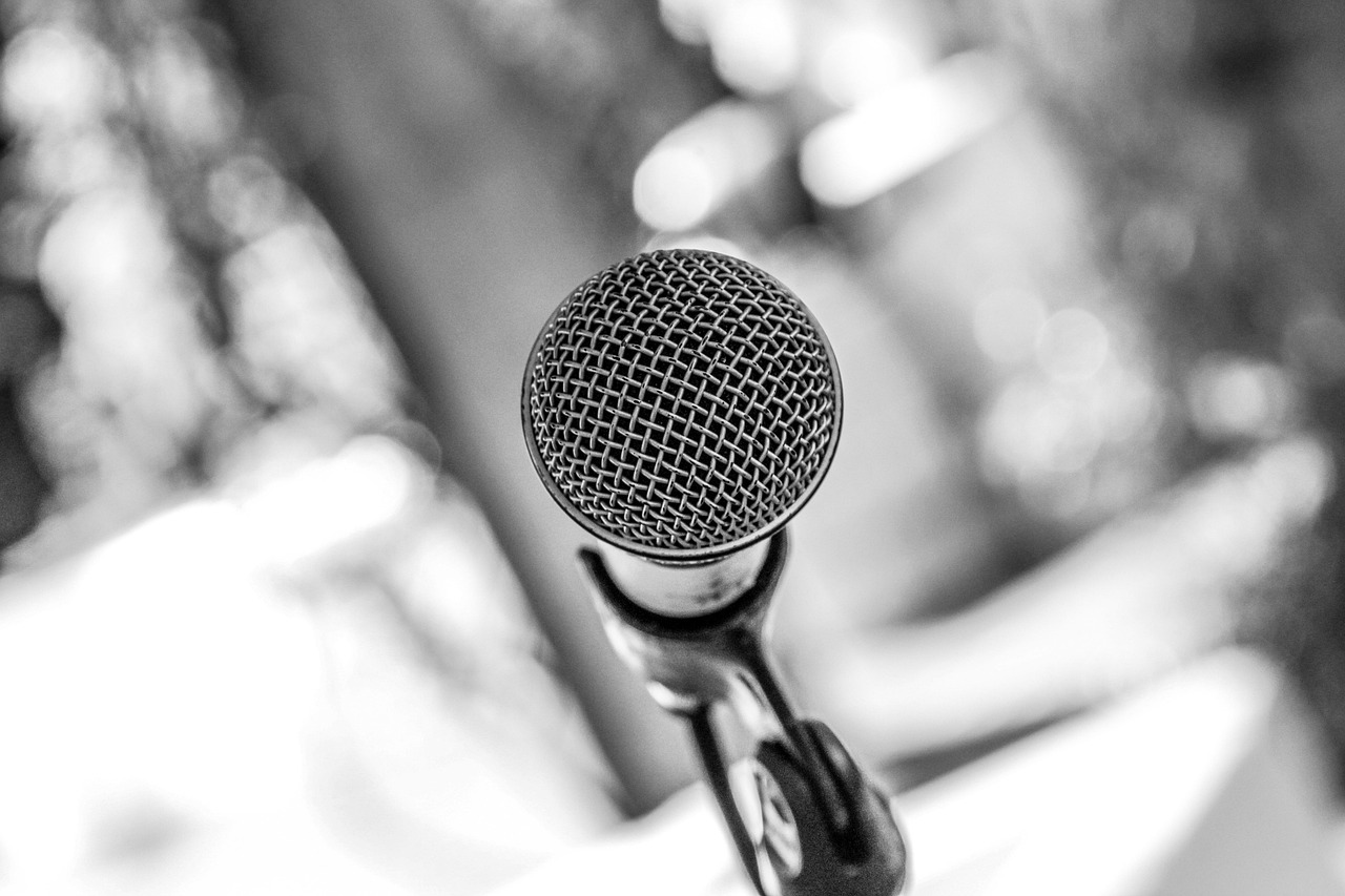 Black and white close-up of a microphone, symbolizing podcasting and audio recording
