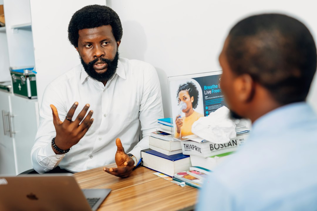 Professional consultant discussing business legal matters with a client across an office desk