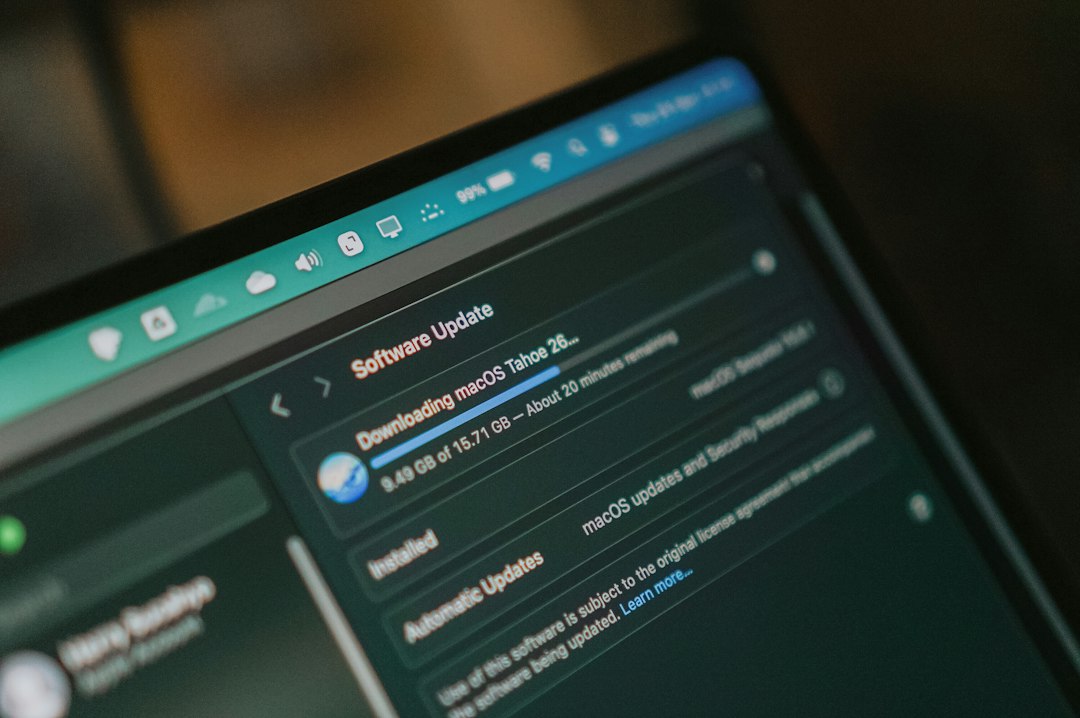 A laptop screen displays a software update downloading with a progress bar