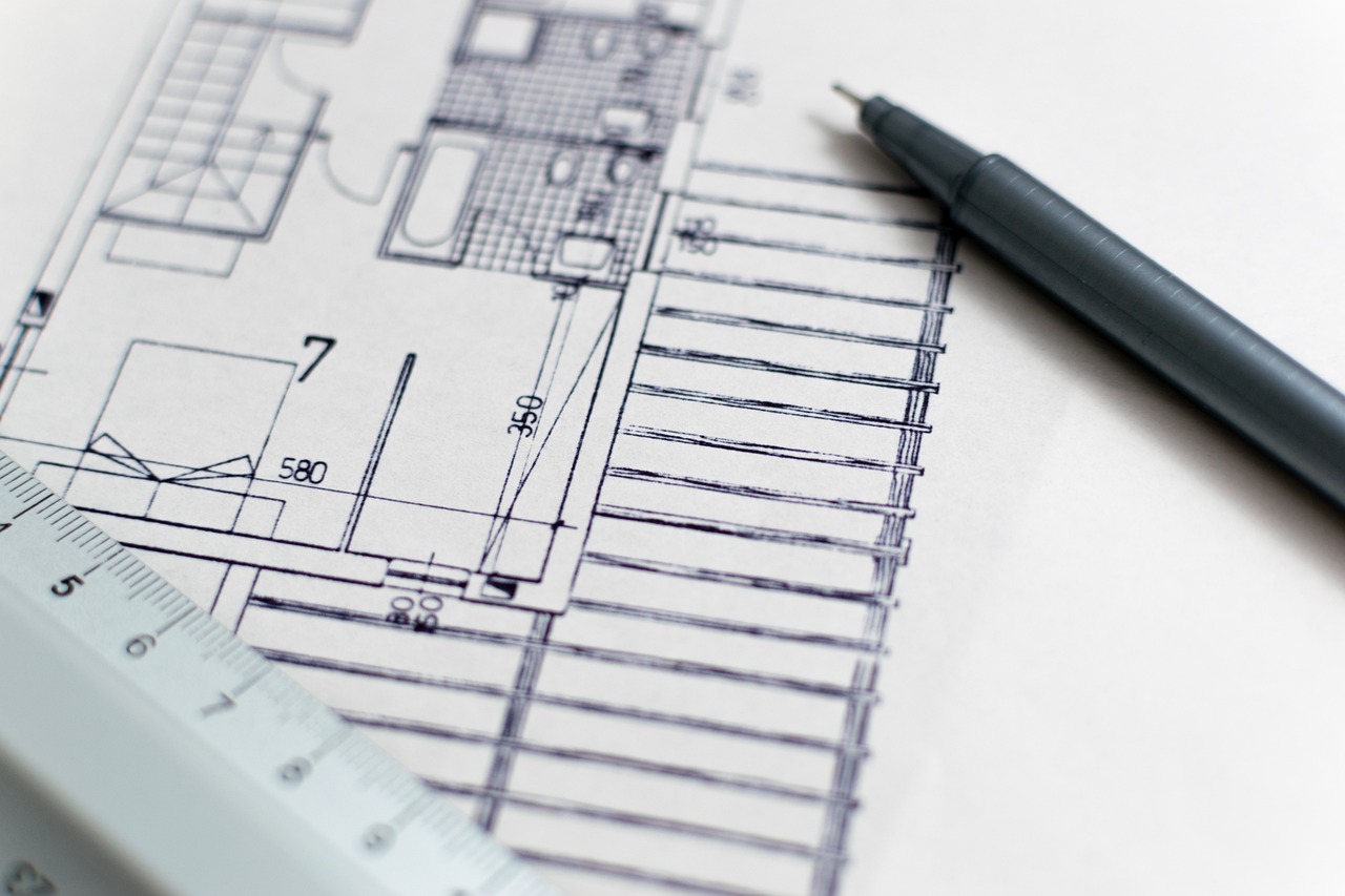 Architectural blueprint with a pen and ruler, representing a survey plan