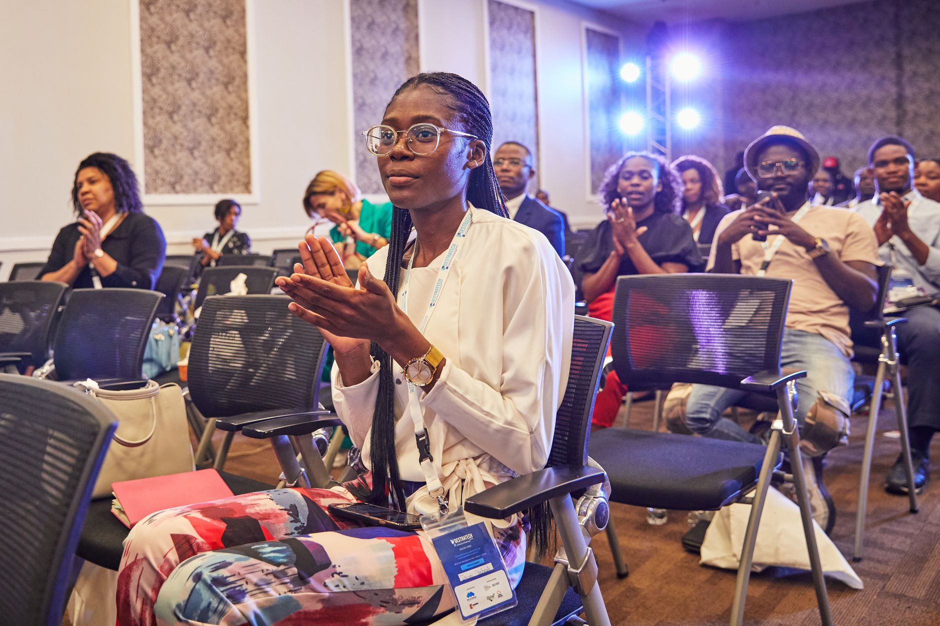 Attendees clap during a presentation at an event industry conference