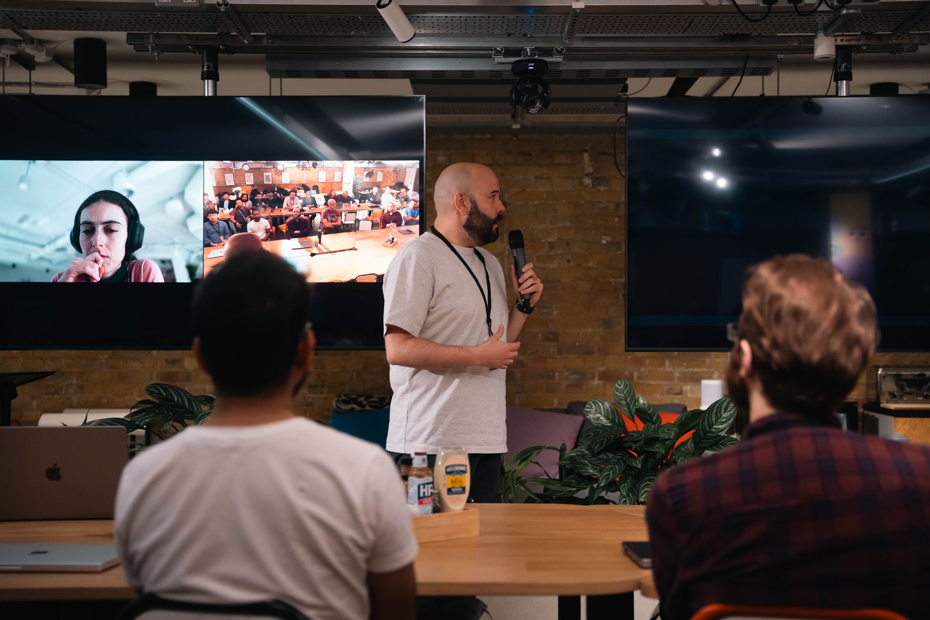 Speaker addresses in-person and virtual attendees at a hybrid event conference