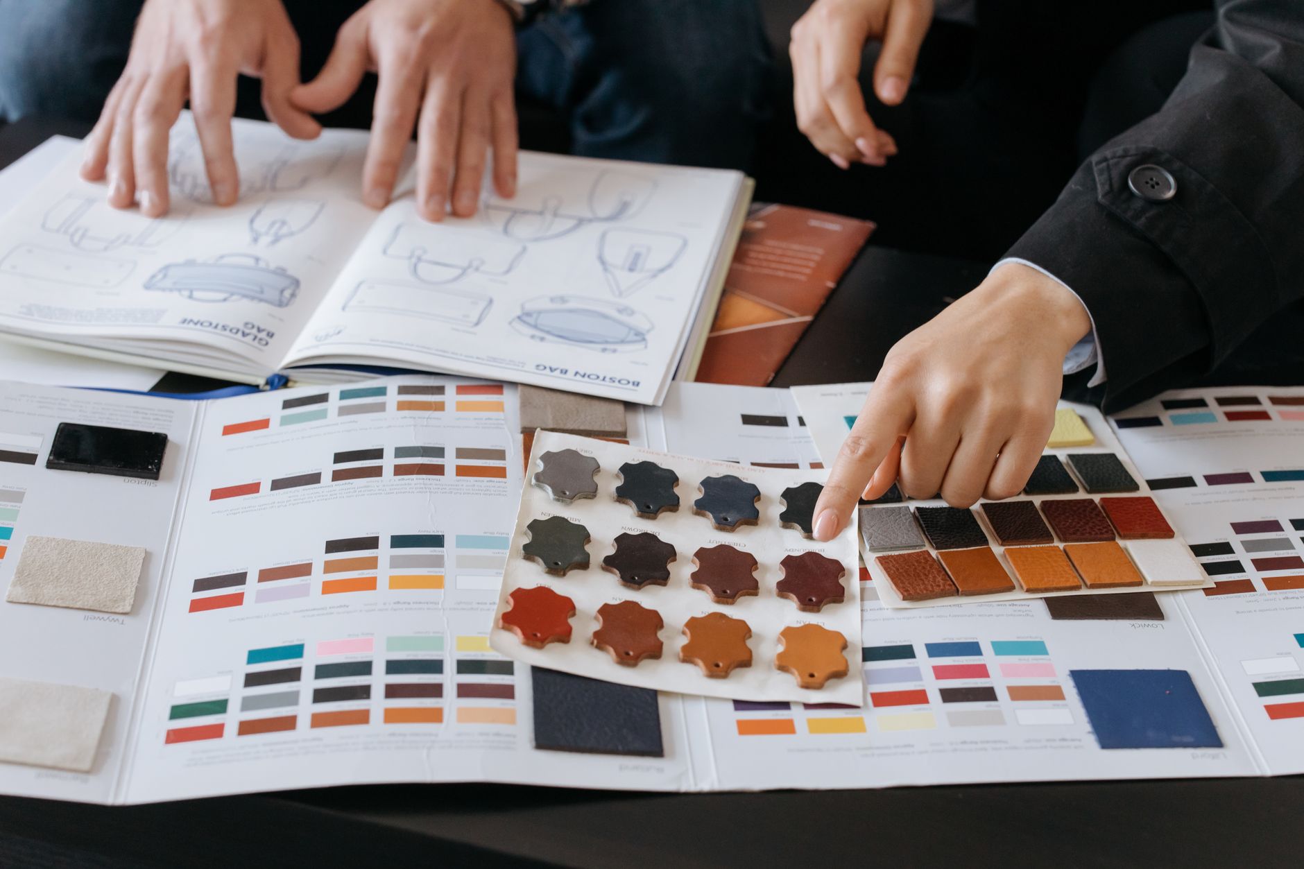 Designers review material samples and color palettes for branding projects