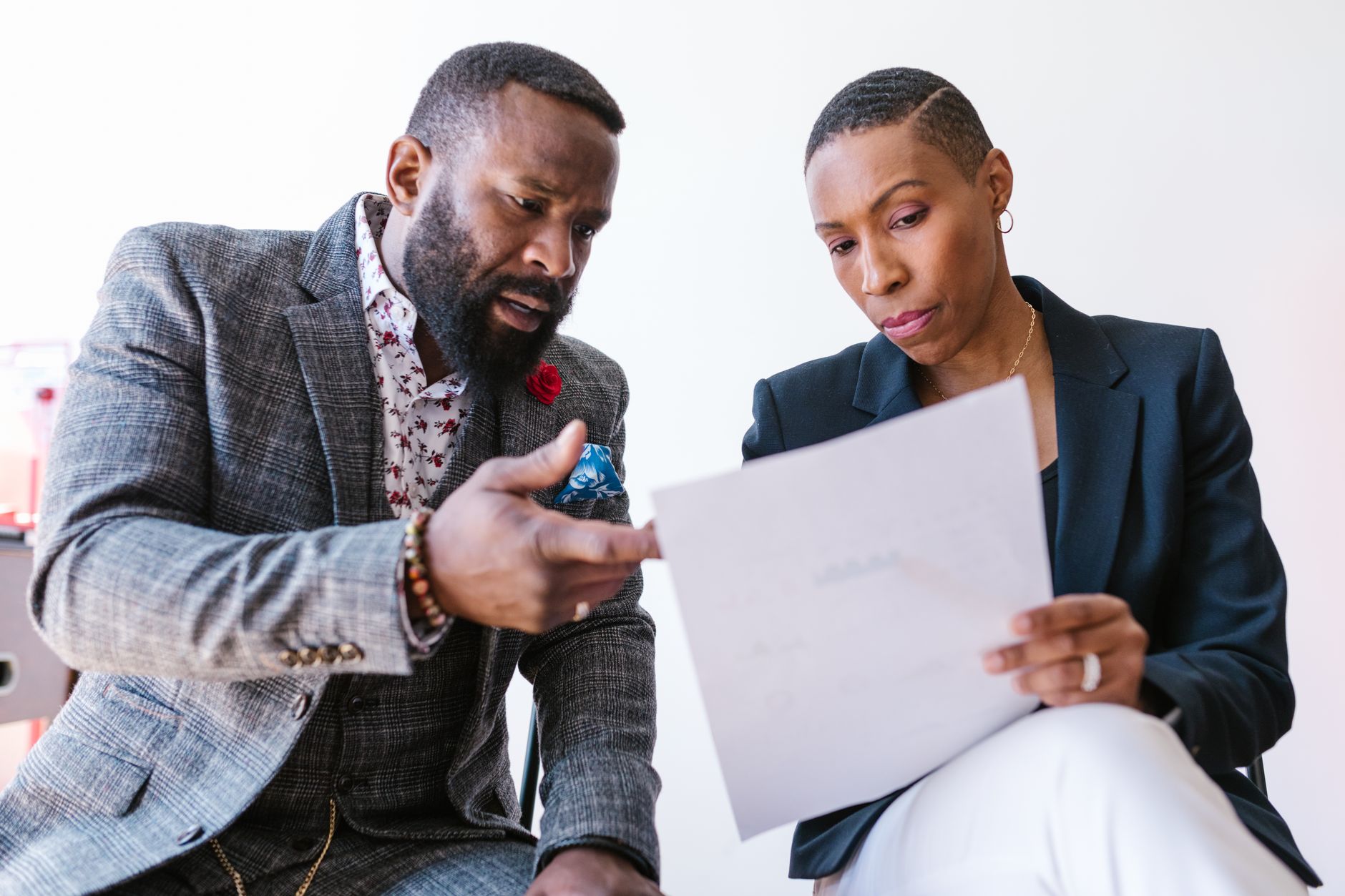Two professionals reviewing a document, possibly discussing commercial litigation matters