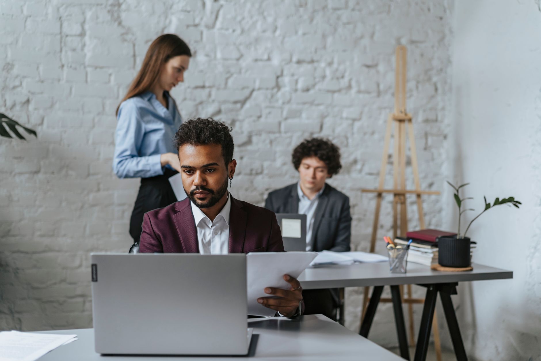 Two lawyers work diligently at desks in a modern office environment