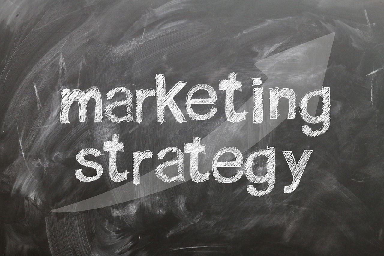 Chalkboard says "marketing strategy" with an upward arrow, signifying growth and planning