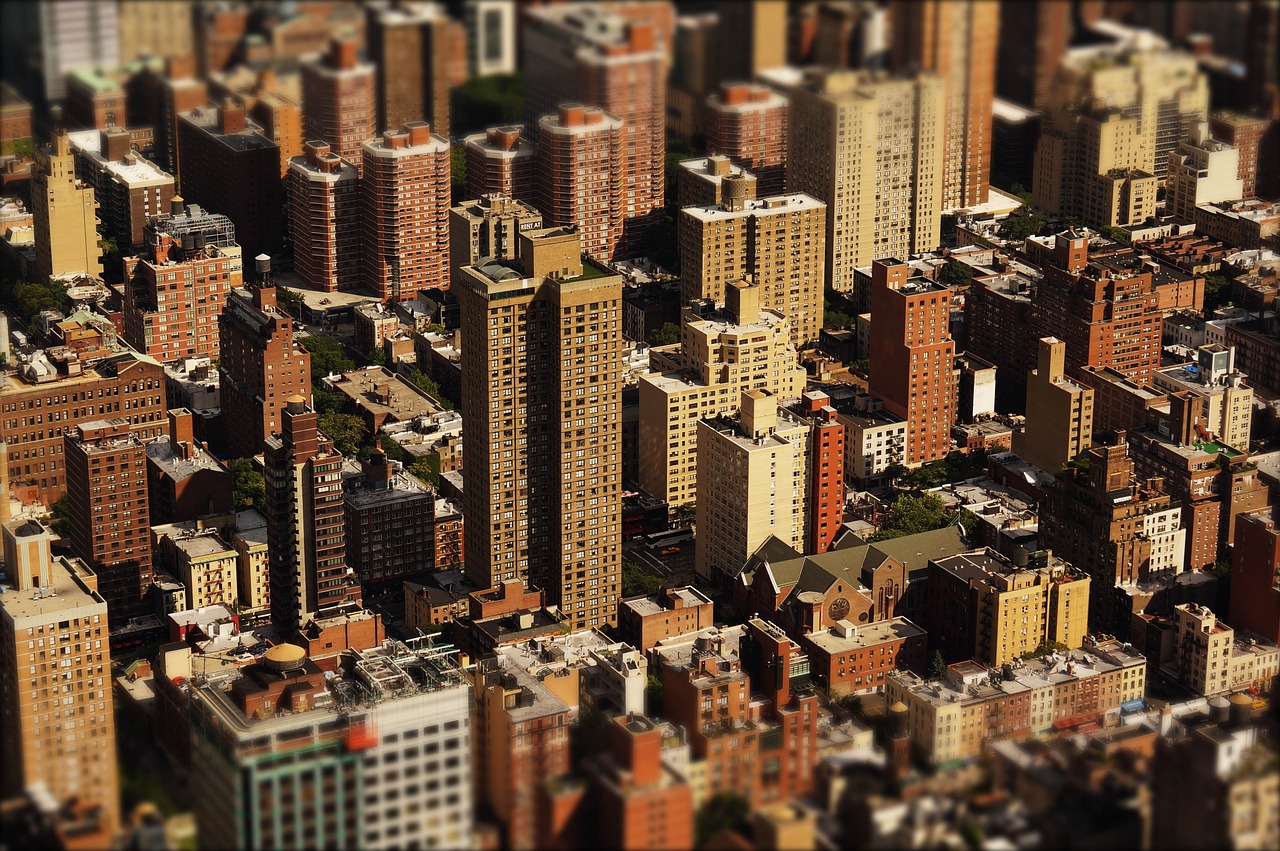 Aerial view of dense urban residential and commercial real estate buildings with tilt-shift effect