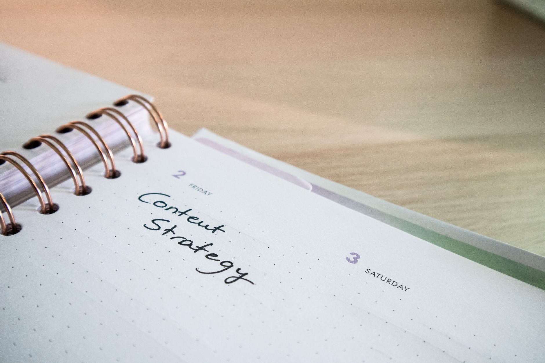 Open planner with "Content Strategy" handwritten on Friday's page