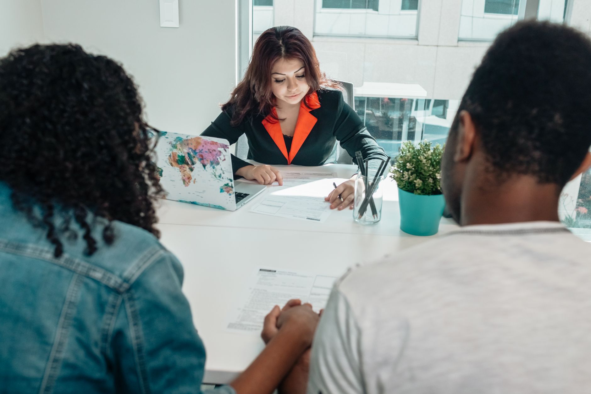 Legal counsel reviews documents with a couple, avoiding conflicts of interest in property transactions