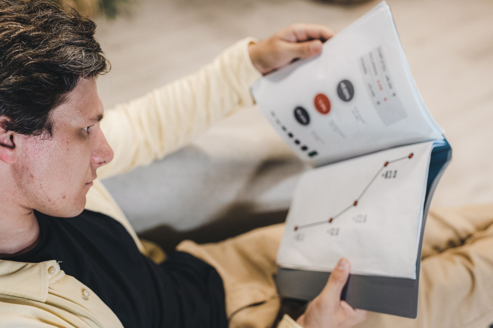 Man studies charts in a report, likely analyzing website ranking data