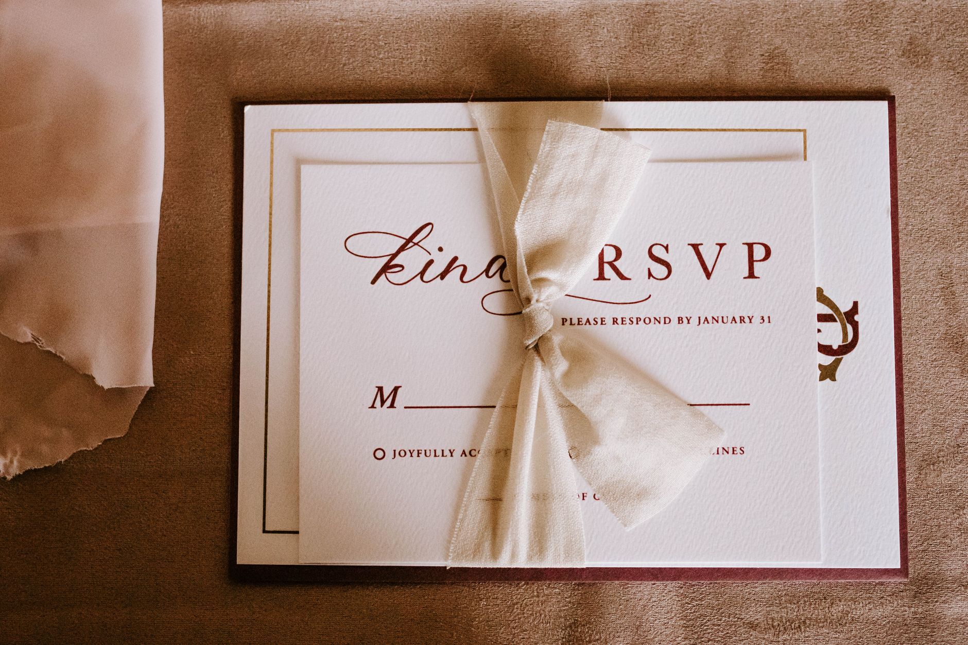 Elegant wedding RSVP card with a cream ribbon for a Nigerian wedding guest