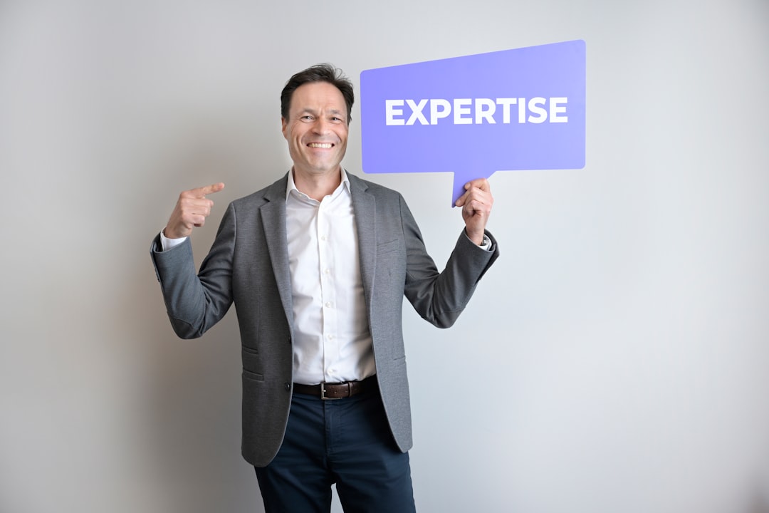 A smiling man points to himself and holds a speech bubble saying "EXPERTISE"