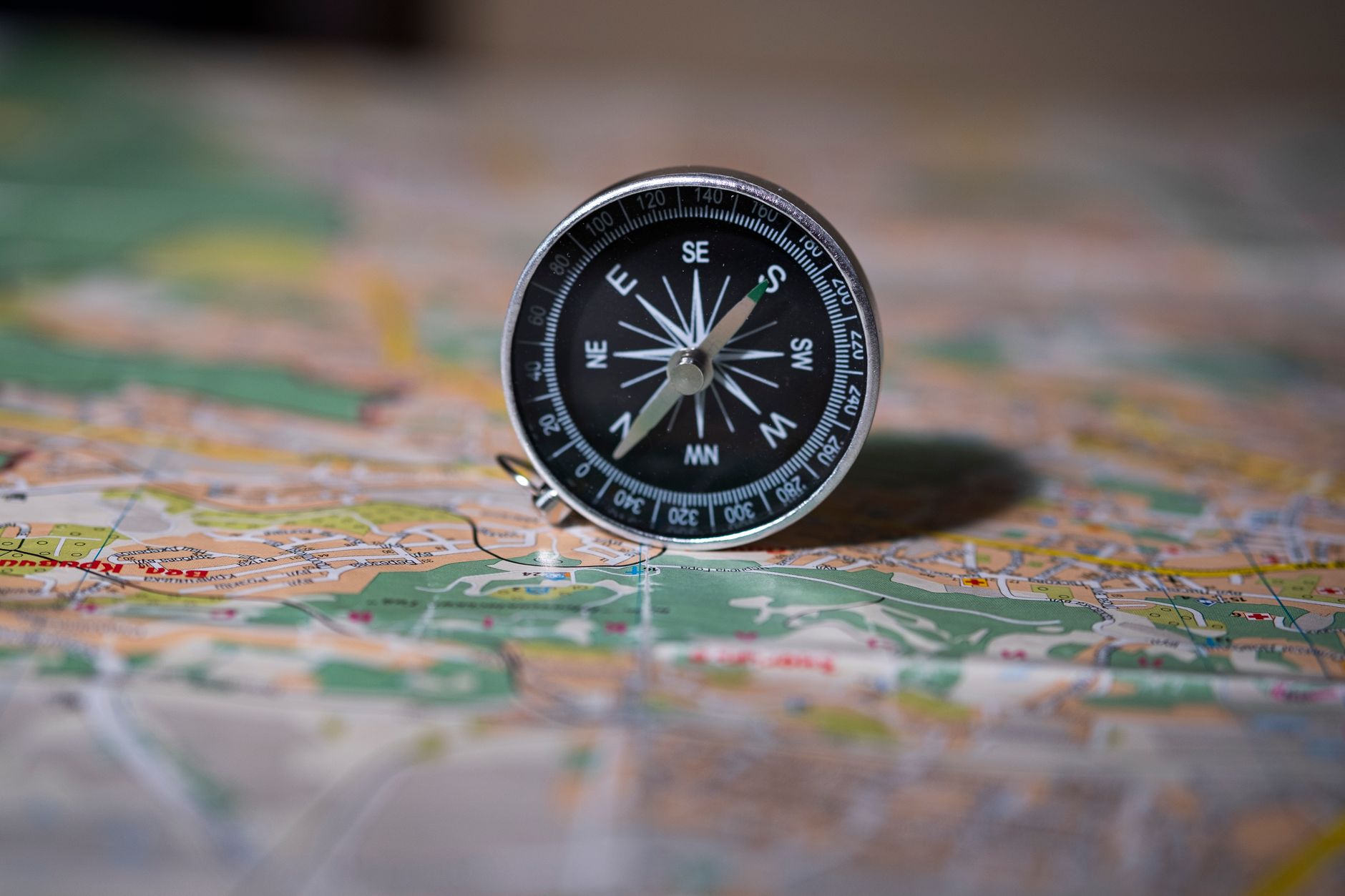 A silver compass on a detailed map, guiding the customer journey or business growth