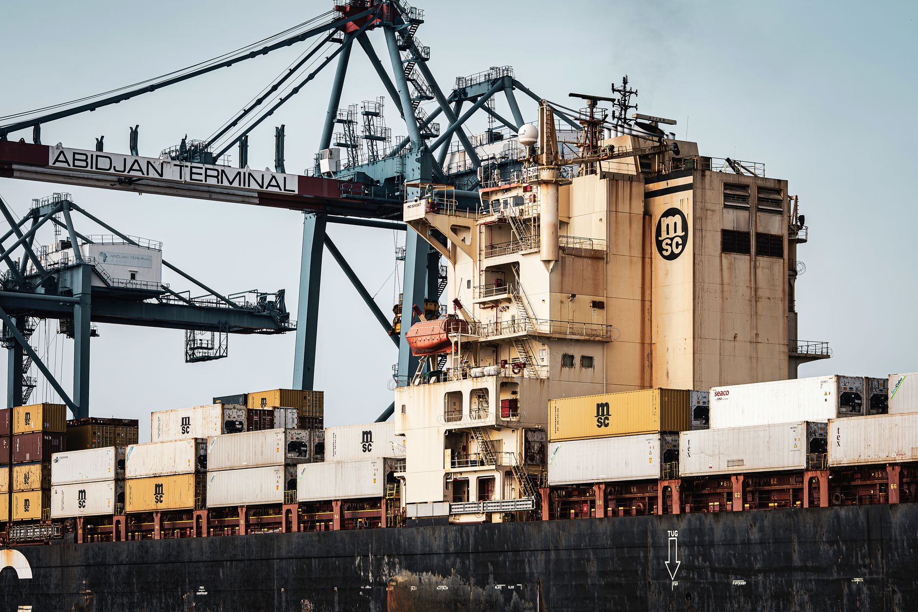 Large container ship with MSC containers docked at Abidjan Terminal, illustrating African trade infrastructure