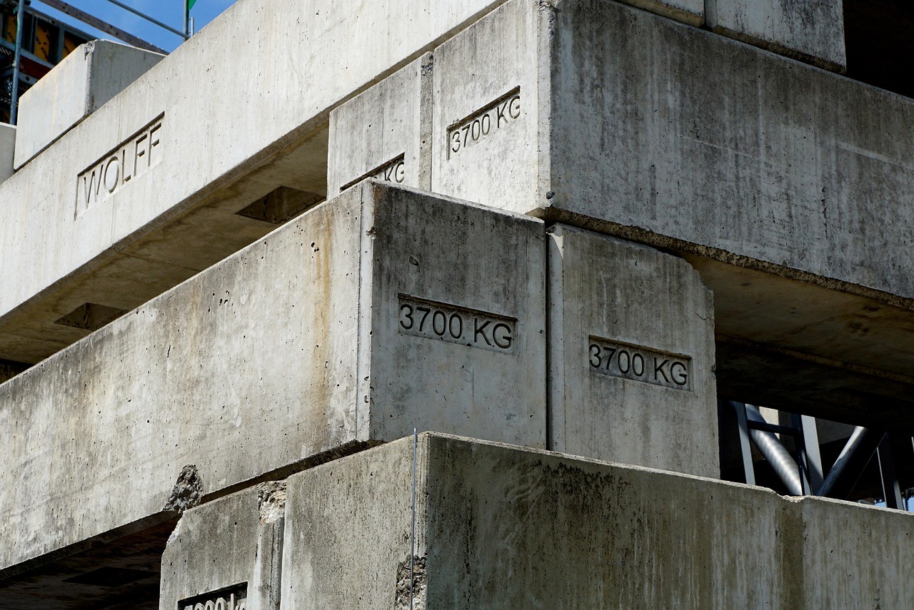 Stacked concrete blocks with "3700 KG" and "WOLFF" etched into them