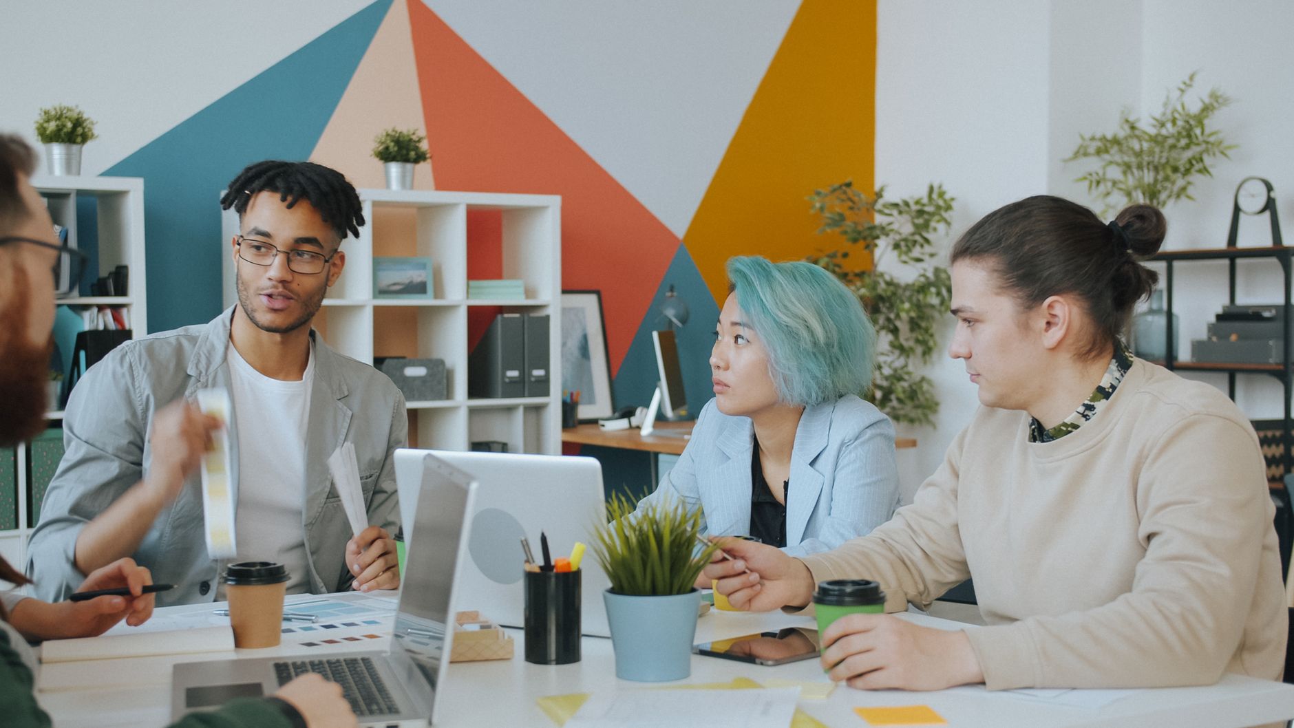Diverse team discussing client strategy and content plans around a modern office table