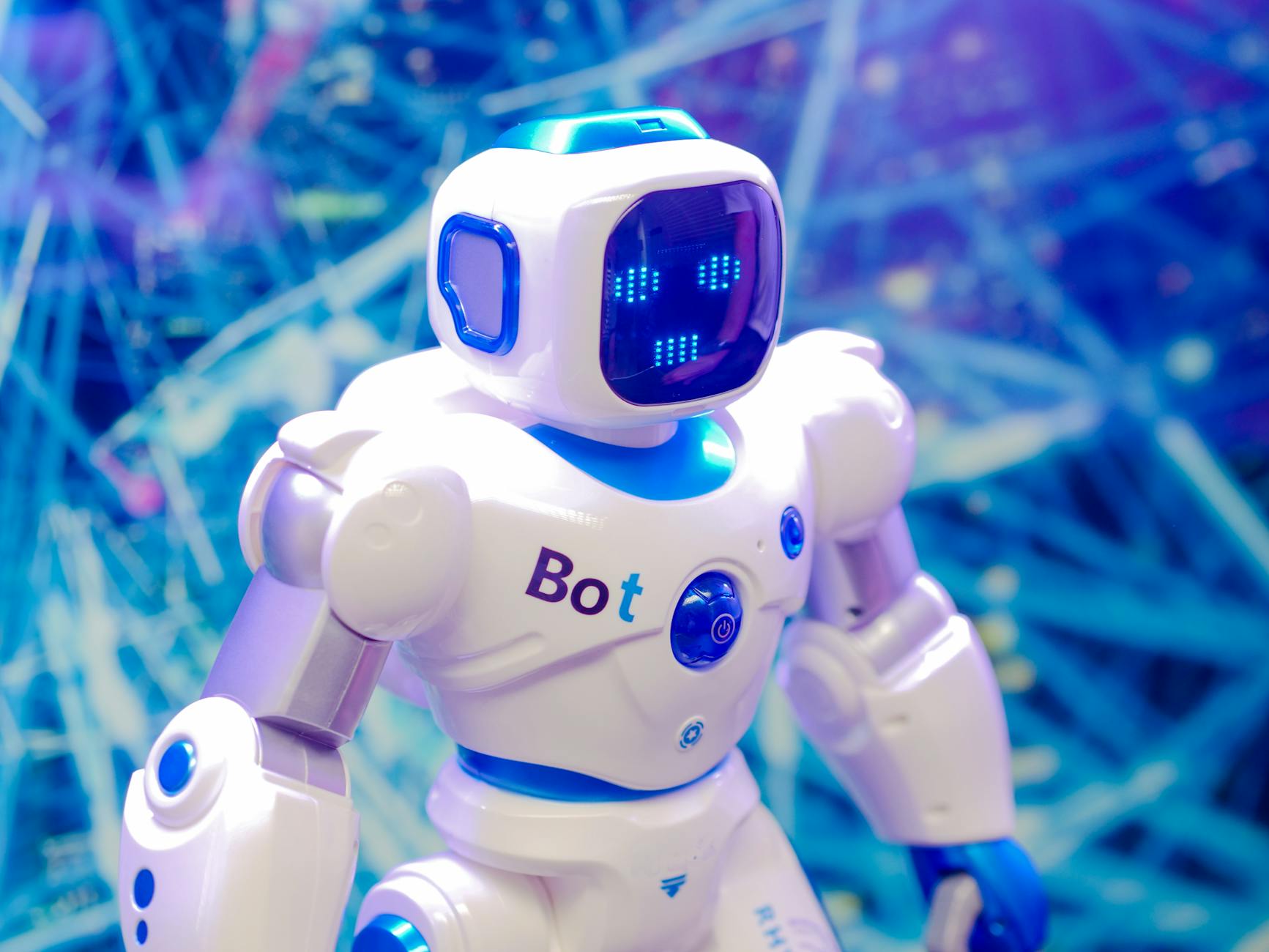 White and blue robot with an illuminated face stands against a tech background