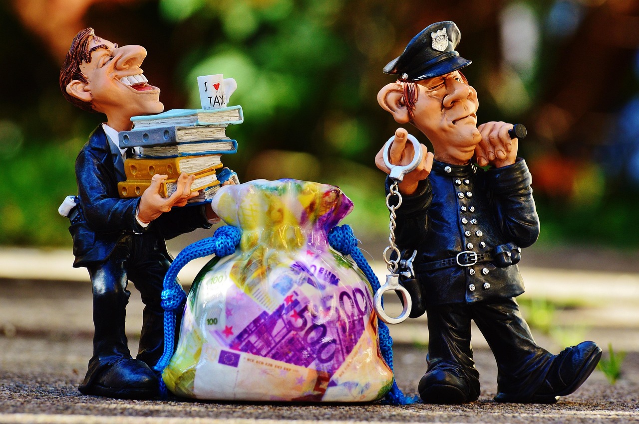 Caricatures of a smiling man, money bag, and stern policeman with handcuffs