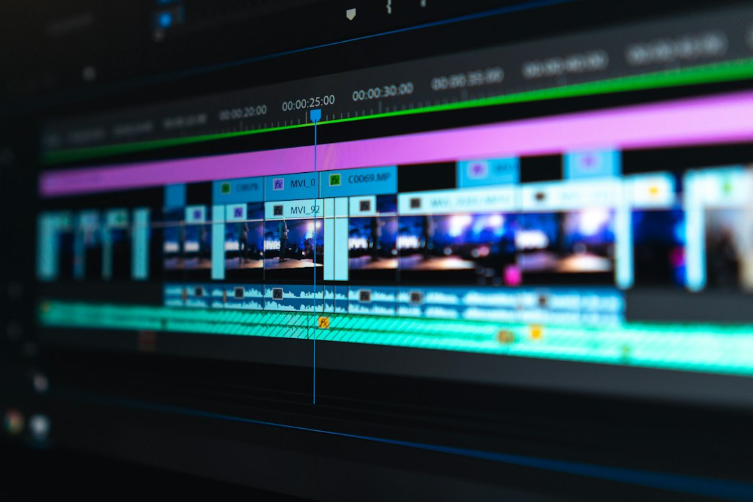 A computer monitor displays an editing timeline with video and audio tracks
