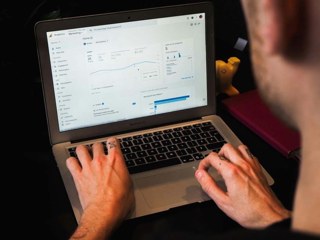 Person analyzing website traffic data in Google Analytics during an SEO audit