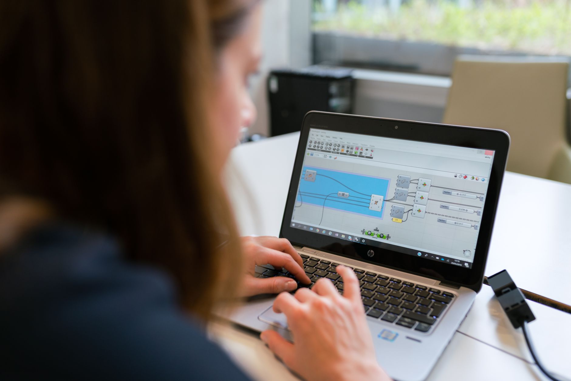 Woman typing on a laptop analyzing technical workflows for a website audit