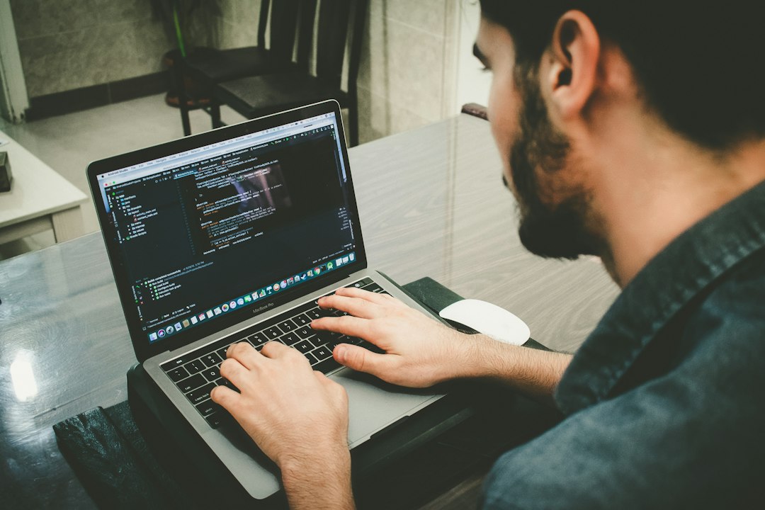 A developer reviews website code on a laptop during a technical SEO audit