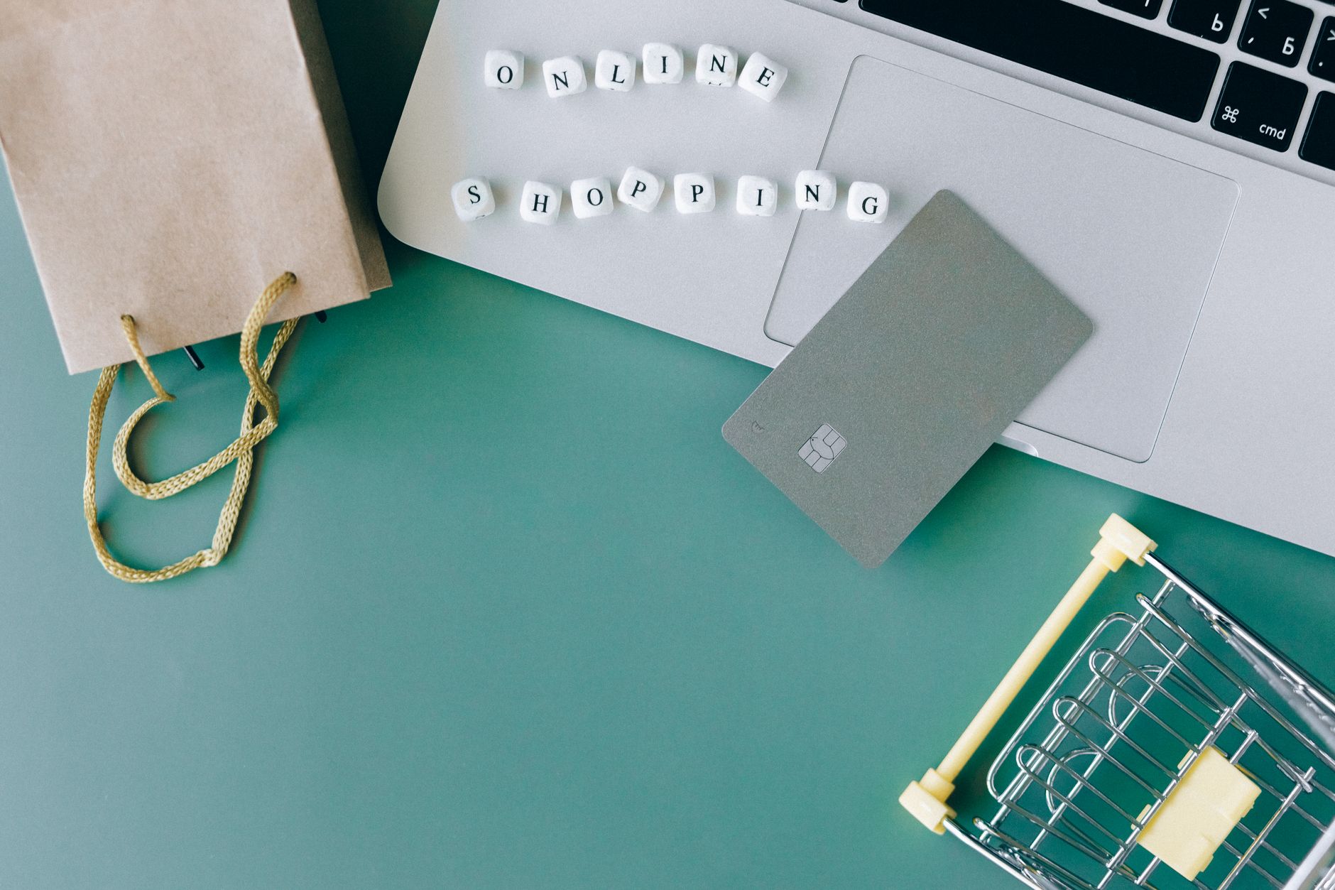 Laptop, credit card, and shopping items representing eCommerce conversions and online shopping