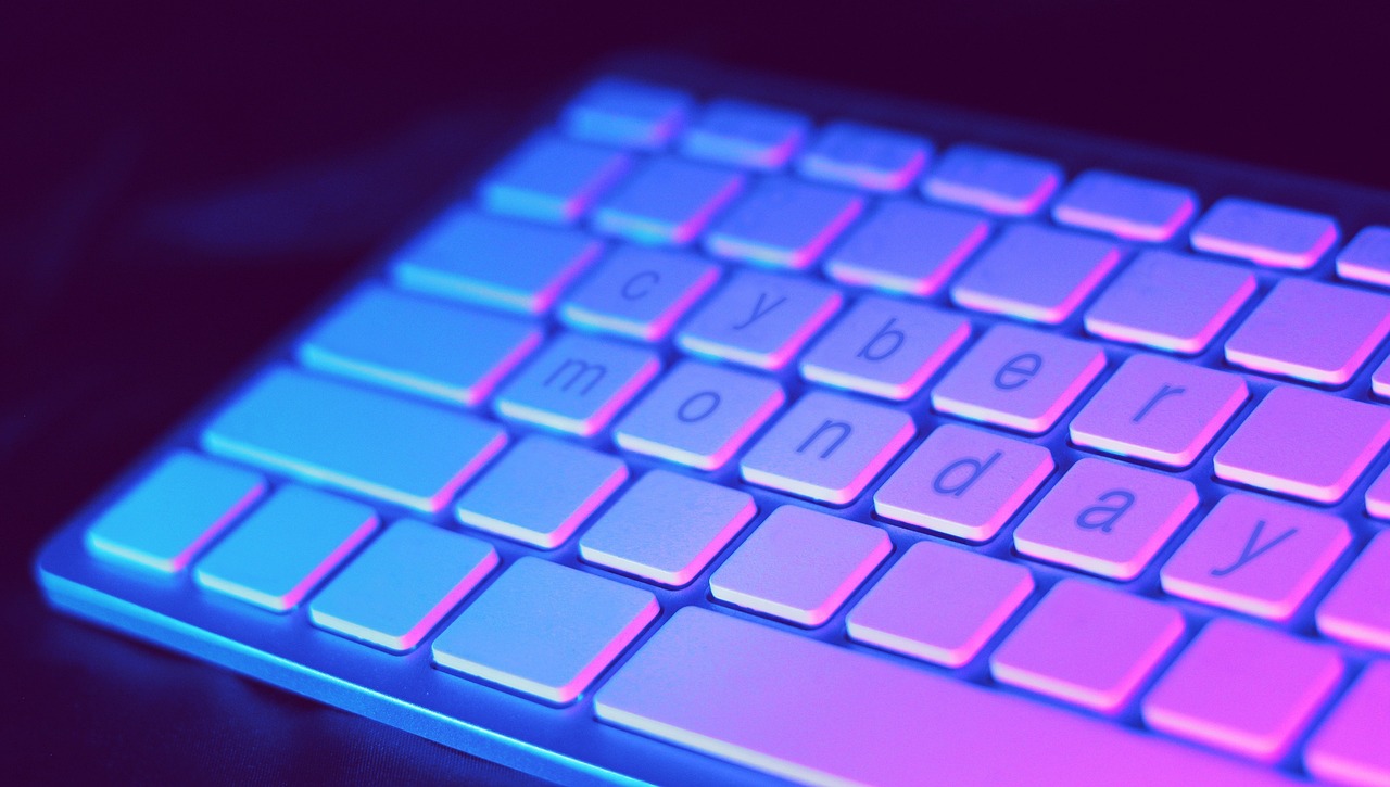 A keyboard with "cyber monday" highlighted in glowing blue and pink letters